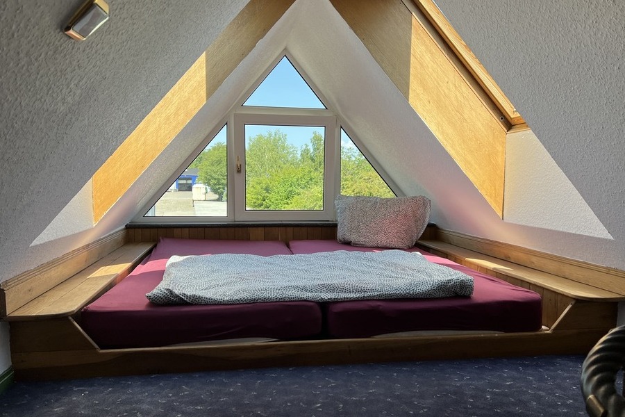 Bett unter Spitzdach